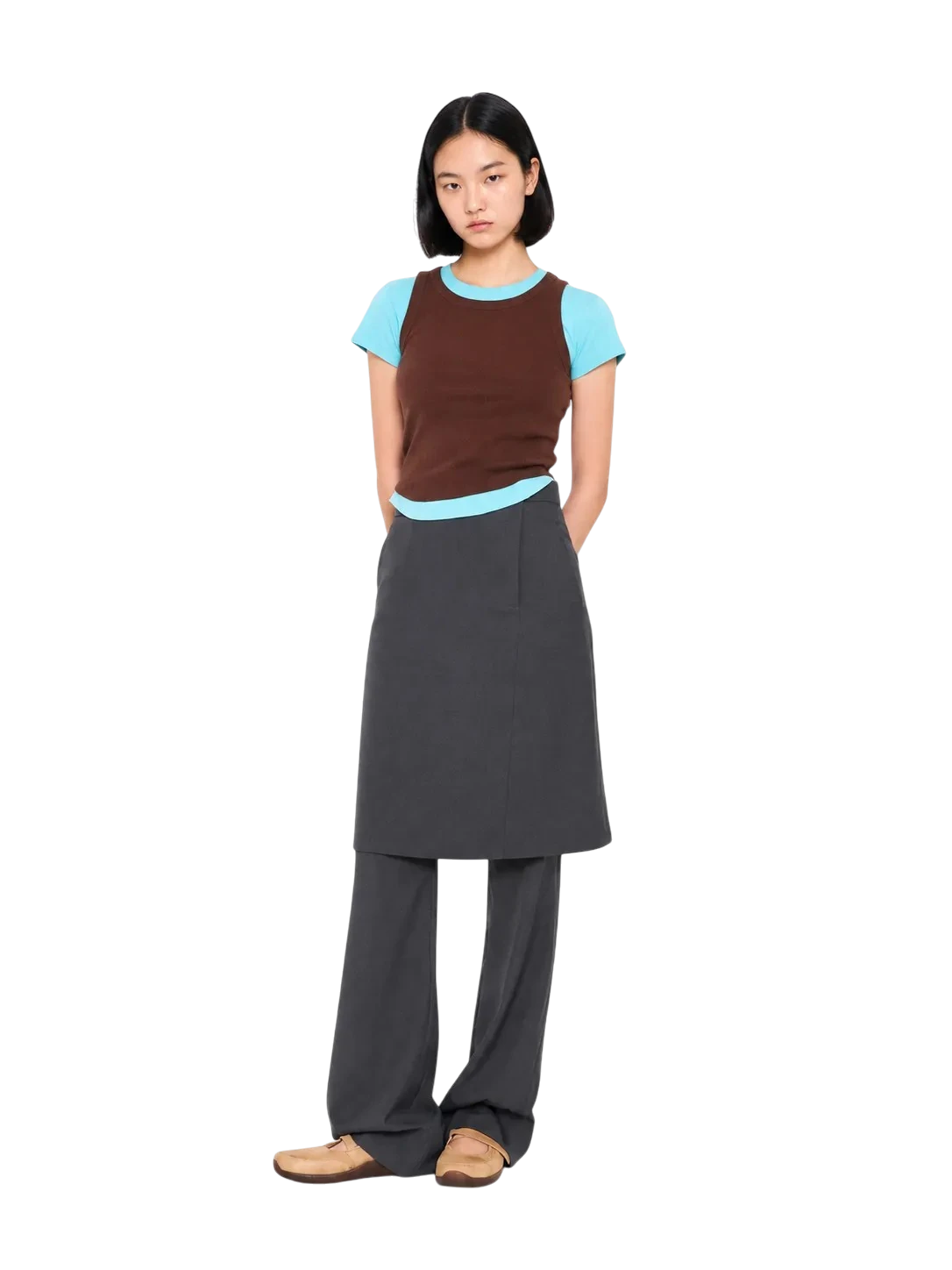 AI-generated model wearing a brown knit vest over a light blue tee and a charcoal skirt over trousers