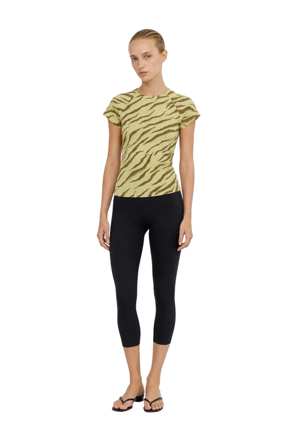 AI-generated model wearing a zebra-print tee and black capri leggings