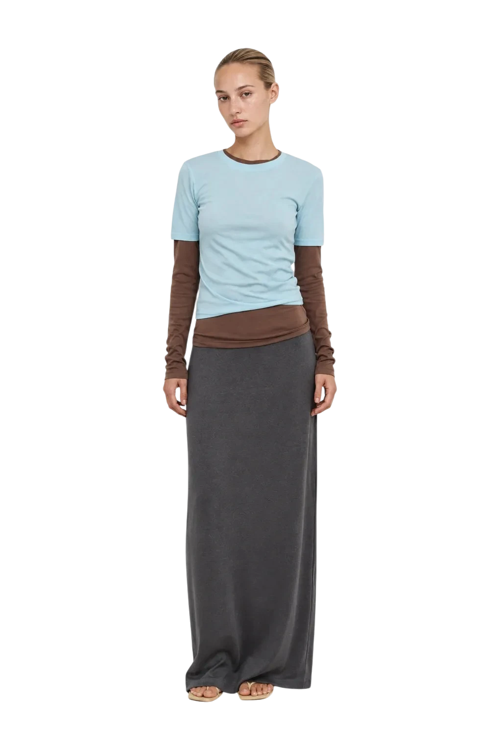 AI-generated model wearing a light blue tee over brown long sleeves and a grey maxi skirt